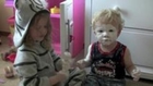 Little Girl Covers Baby Brother in Diaper Cream